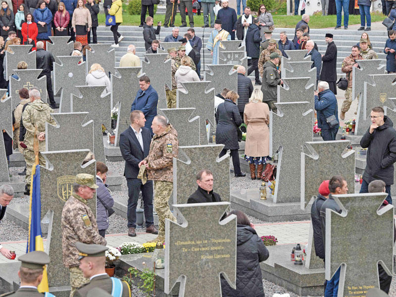 أوكرانيون يزورون مقبرة ليتشاكيف في مدينة لفيف لإحياء ذكرى «المدافعين عن أوكرانيا» (أ ف ب)